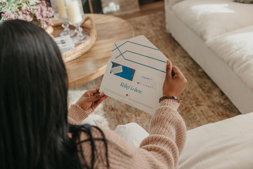 Woman opening a Signal Relief Patch envelope